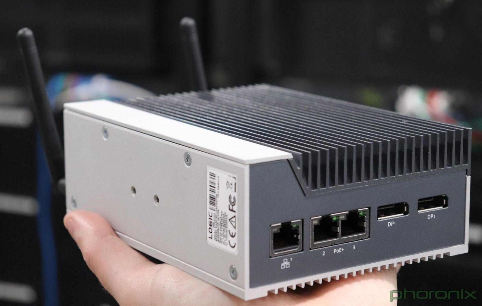 picture of the IPC, a K300, hand-sized aluminium casing with cooling fins and connectors for ethernet and monitores